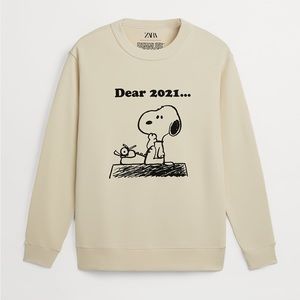 Snoopy Peanuts cream sweatshirt.